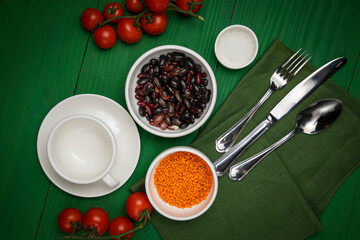 The dishes are laid out on a wooden table. Cherry, grass, utensils, sea salt
