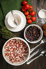 The dishes are laid out on a wooden table. Cherry, grass, utensils, sea salt
