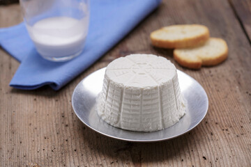 Ricotta cheese on wood background