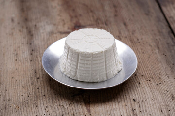 Ricotta cheese on wood background