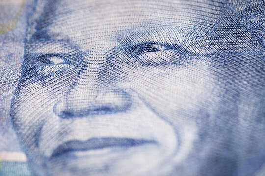 Horizontal marco detail of the image of Nelson Mandela in the obverse of South African ZAR banknote with a denomination of 100 rand