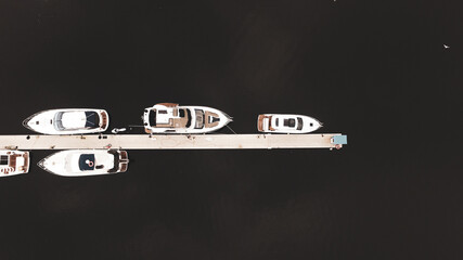 Many beautiful white yachts sail along the river in the autumn.