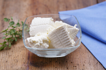 Ricotta cheese on wood background