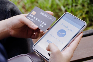 Online shopping, mobile payment. Woman hands holding credit card and using smart phone for online payment