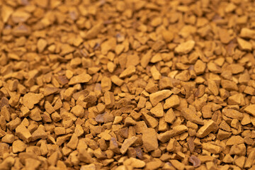 Granules of instant aromatic brown coffee background. Macro shot.