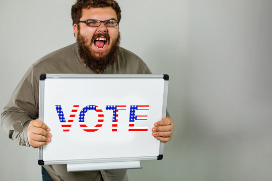 Man shows board with Vote sign. Voting concept. Make the political choice, use your voice. Bearded guy in sunglasses invite to go to the presidential elections.