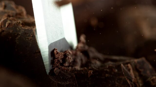 Super slow motion of cutting off dark chocolate pieces by chisel. Filmed with cinema high speed camera, 1000fps.