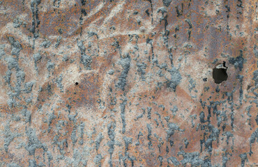 The surface of old metal objects that are rusty and black stained