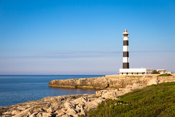 Scenic Artrutx Lighthouse at sunset in Minorca, Spain