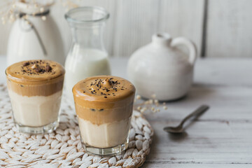 Dalgona whipped coffee, instant, cream, iced coffee. Cocktail with coffee, milk and ice cubes on white background mockup. Trendy drink background with copy space for text.