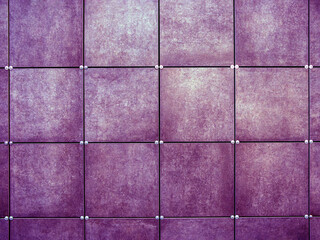 Wall  made of purple square tiles