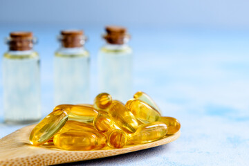 Fish oil capsules on a blue background - omega 3 vitamins and health concept