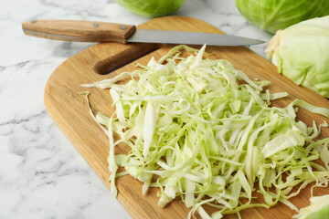 Chopped ripe cabbage on white marble table, closeup