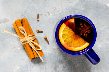 Top view mulled wine and spices on gray background