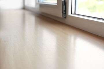 Closeup of plastic window with wooden sill