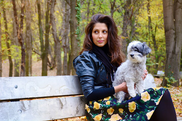 Beautiful Smiling Woman Playing  with her Dogs in the Autumn Park .Pets and Happy Owner Outdoor in the Nature