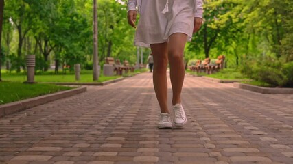 female feet in shoes b roll pedestrian on footpath woman walking on sidewalk summer city slow motion - Powered by Adobe