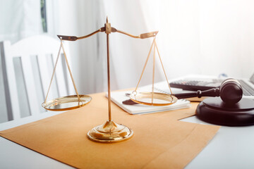 Business and lawyers discussing contract papers with brass scale on desk in office. Law, legal...