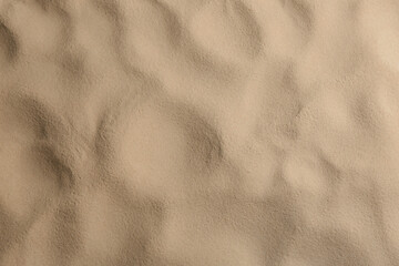 Dry beach sand as background, top view