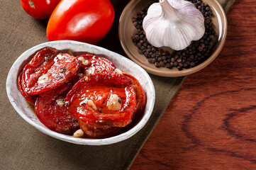 .Sun-dried tomatoes in a bowl with olive oil. Top view, copy space