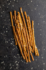 Salty sticks. Crunchy pretzels with sesame seeds.