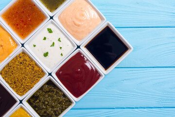 Set of different sauces in ceramic bowl