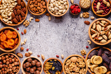 Various Nuts and dried fruits in wooden bowls.
