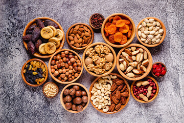 Various Nuts and dried fruits in wooden bowls.