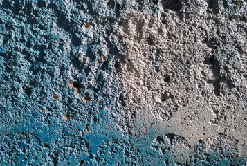 Texture of old cement wall with traces of blue grunge paint.
