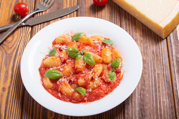Italian homemade potatoes gnocchi with tomatoes sauce