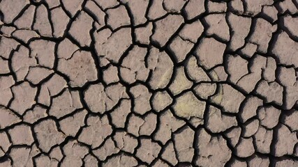 Dry lake bed with cracked Soil, Aerial view.
 - Powered by Adobe