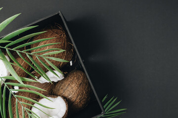pile of coconuts, tropical fruits on black background