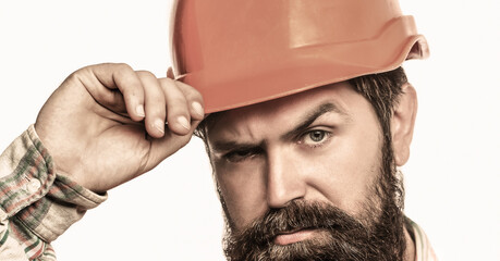 Builder in hard hat, foreman or repairman in the helmet. Bearded man worker with beard in building helmet or hard hat. Man builders, industry