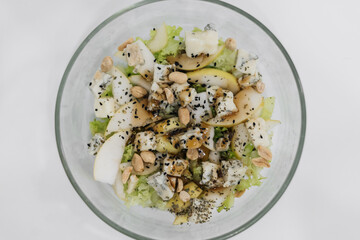 homemade healthy fresh salad with blue cheese, pears, nuts and balsamic dressing, vegetable salat
