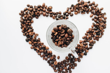 Close-up view of roasted coffee beans, isolated on white 
