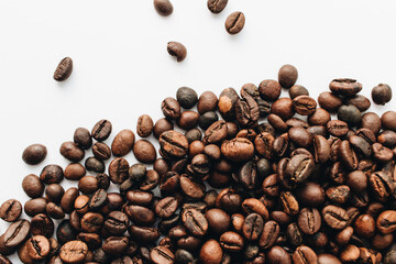Close-up view of roasted coffee beans, isolated on white 