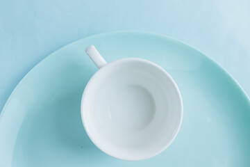 clean white cup and blue plate 