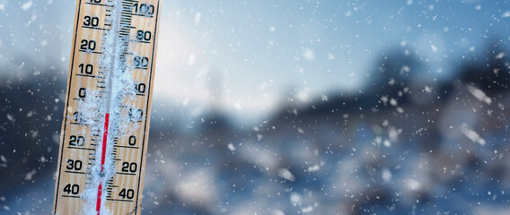 Winter time. Thermometer with blur backround  shows low temperatures