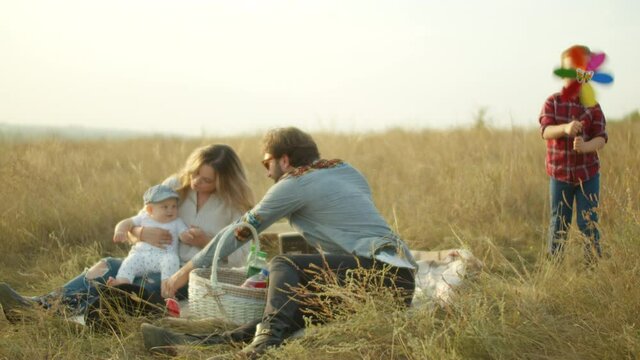 Family having picnic in field in countryside