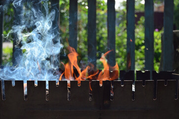 Picnic. Photo for the background: the fire is burning in the grill.