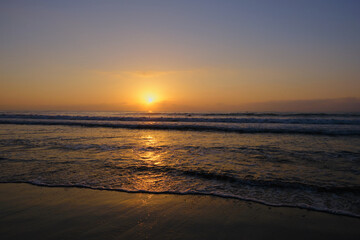 a glorious orange sunrise over a calm blue sea