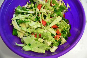 Food. Fresh salad in a purple bowl. Photo for the background.