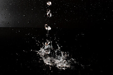 Splash of clear water on black isolated background.