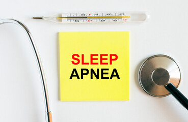 Yellow sticker with the text Sleep Apnea. A thermometer with a phonendoscope on a white background
