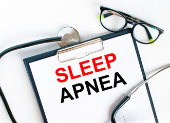Text Sleep Apnea in the folder with the stethoscope and glasses