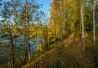Beautiful autumn evening on the bank of the quarry.