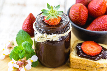 strawberry with homemade jam, spot focus. Organic fruit used in jam or artisan jam