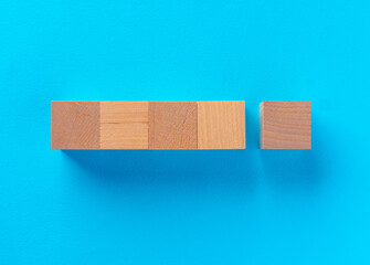 Top view of wooden toy blocks on blue