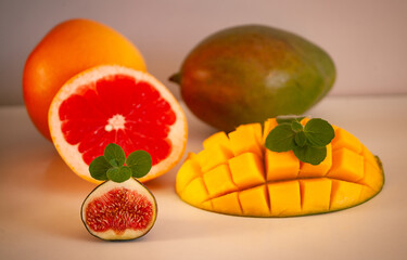 Fresh bright mango fruit, figs, grapefruit, orange