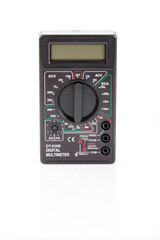 Digital electrical tester multimeter in black case isolated on white background. Digital multimeters have a numeric display, can measure voltage, current and resistance. Close-up.